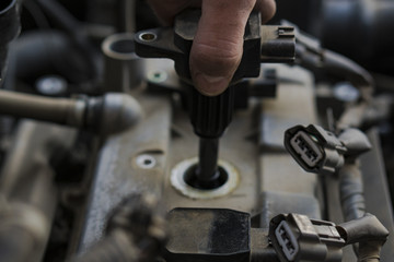 Car engine repair. Replacing the spark plugs in the engine.