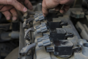 Car engine repair. Replacing the spark plugs in the engine.