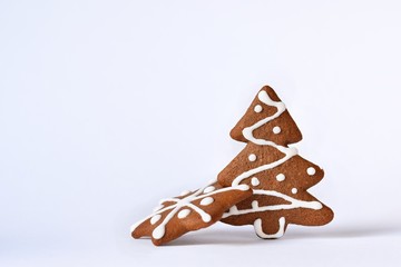 Christmas tree and snowflake. Beautiful sweet Christmas candy. Hand-decorated, homemade gingerbread isolated on a clean white background.