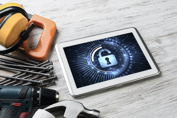 Web security and technology concept with tablet pc on wooden tab