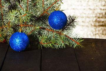 Christmas background decoration with small gifts, and a spruce branch on an old board.