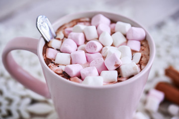 Pink mug of hot chocolate with marshmallows on table, top view