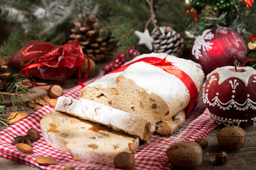 Traditional Christmas dresden cake stollen with candied fruits and almonds. Christmas New Year decoration.