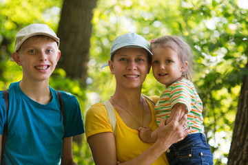 mother with two children in nature.