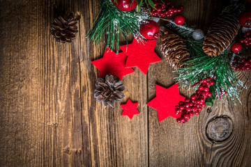 Christmas wooden background with cone and snow tree.
