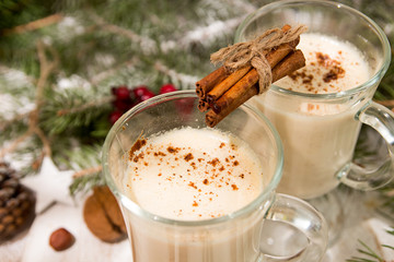 Eggnog, winter Christmas traditional hot drink with milk, eggs, rum. Christmass New Year decoration with gingerbread cookies.