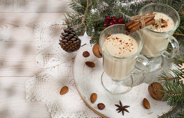 Eggnog, winter Christmas traditional hot drink with milk, eggs, rum. Christmass New Year decoration with gingerbread cookies.