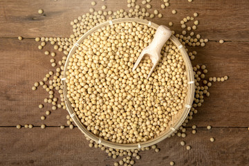 Soy beans with wooden spoon in bamboo basket