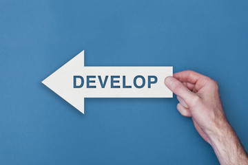 Develop arrow direction held on a blue background