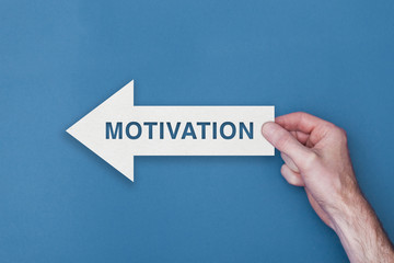 Motivation arrow direction held on a blue background