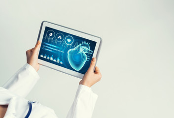 Close of female doctor hands working with tablet pc computer