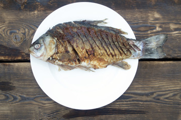 Fried fish on a white plate