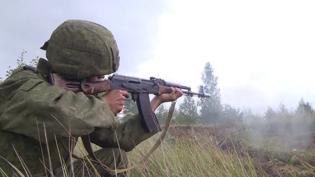 the soldier firing from one knee from a Kalashnikov