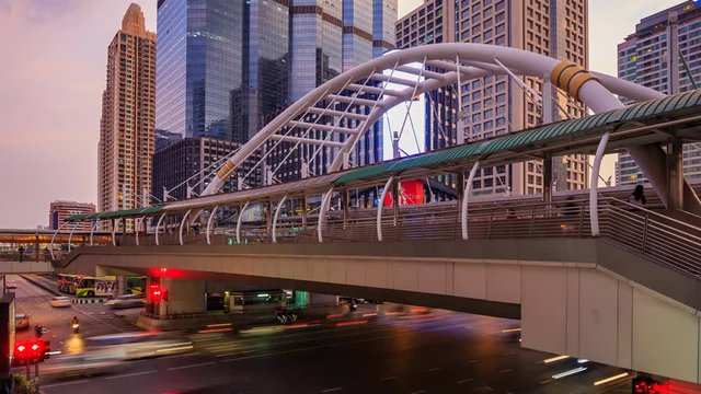 day to night Time-lapse of public sky walk and traffic at Chong Nonsi sky train station, Bangkok, Thailand