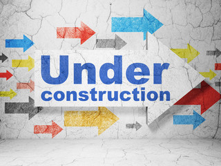 Web development concept:  arrow with Under Construction on grunge textured concrete wall background, 3D rendering