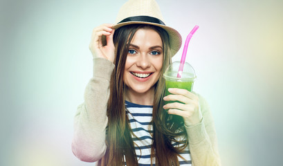 Hipster girl holding glass with green juice.