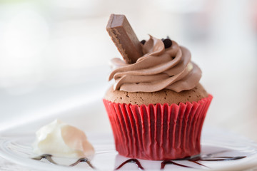 Cupcakes, muffins cake with cream on the table at the wood table a delicious cupcake on a homemade muffin dish..