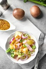 Composition with delicious potato salad and mustard sauce on table