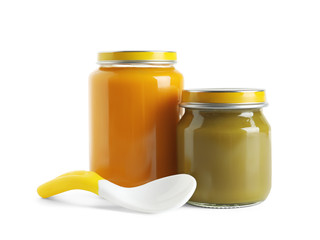 Jars with healthy baby food on white background