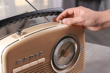 Person tuning retro radio, closeup