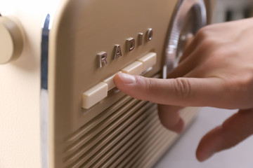 Person tuning retro radio, closeup