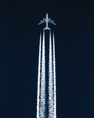 Airplane in the sky leaving contrails