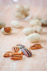 Nice pecan nuts over pink plastic board.