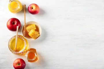 Composition with honey and fruit on wooden background