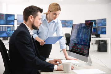 Stock traders working in office