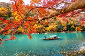 Foto auf Acrylglas Japan Bootsmann stochert das Boot am Fluss. Arashiyama in der Herbstsaison entlang des Flusses in Kyoto, Japan.