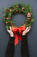 Christmas wreath on a wooden background © Mykhailovskyi