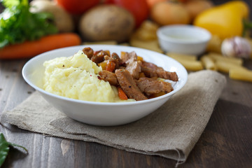 Soy meat with potato puree over kitchen table.