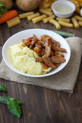 Soy meat with potato puree over kitchen table.