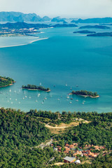 View of blue sky, sea and mountain seen from Cable Car viewpoint, Langkawi, Malaysia. Picturesque landscape with town among the tropical forest, beaches, small Islands in waters of Strait of Malacca