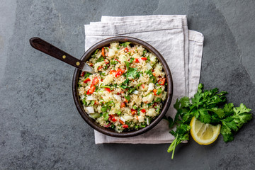Traditional peruvian quinoa quinua salad in clay bowl, slate gray background
