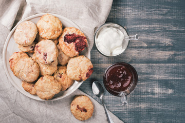 Traditional British dessert, scones with strawberrie. Sweet coconut cookies with raspberry jam and...