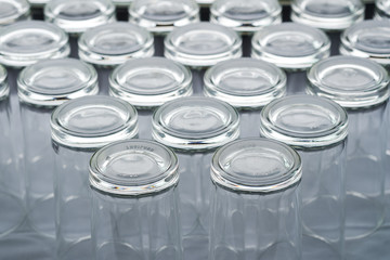 Abstract background of many empty glass of water placed on a table prepared for guests to dining in restaurant.