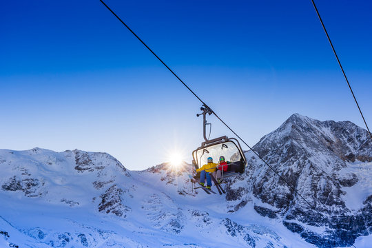 Happy family enjoying winter vacations in mountains. Playing with snow, Sun in high mountains. Winter holidays.