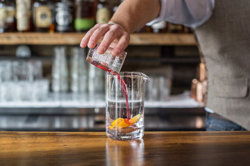 Fototapeta na wymiar Bartender Pouring Mixers into a Cocktail
