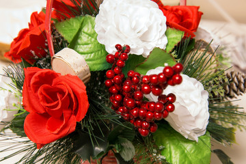 simple Christmas holiday season background silk roses among pine needles and red dried cranberries