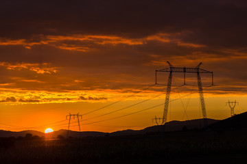 Fototapeta premium Sunset clouds and electric pylon
