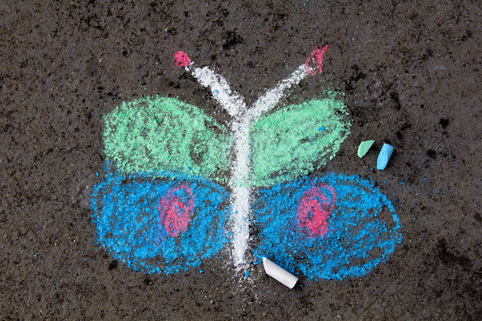 Colorful chalk drawing on asphalt: beautiful butterfly