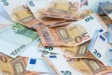 Euro money background from many euro banknotes in different value.
