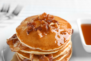 Tasty pancakes with bacon, closeup