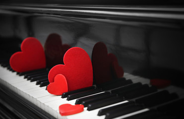 Red hearts on piano keys, close up