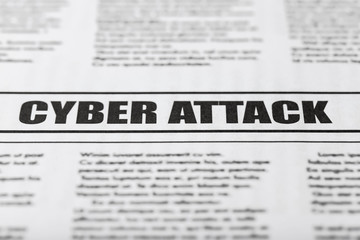 Newspaper with text CYBER ATTACK, close up