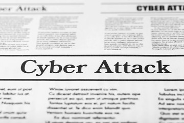 Newspaper with text CYBER ATTACK, close up
