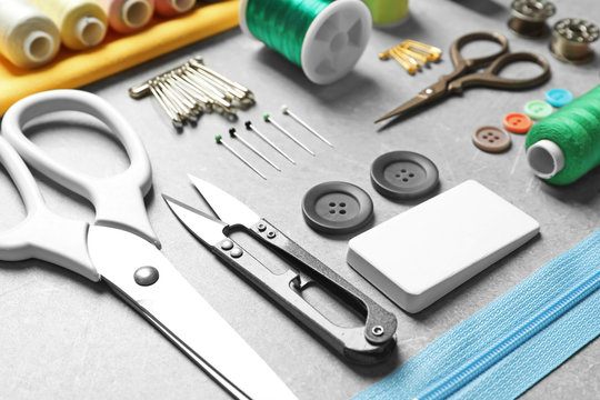 Set of tailoring tools and accessories on table, closeup