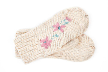 Pair of beautiful white hand mittens. Cute female knitted pair of gloves with a pattern of flowers isolated on white background. Female winter hand accessory.