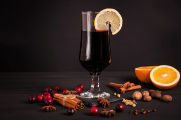 Mulled wine, hot drink with spices on a black background, wine, alcohol, winter